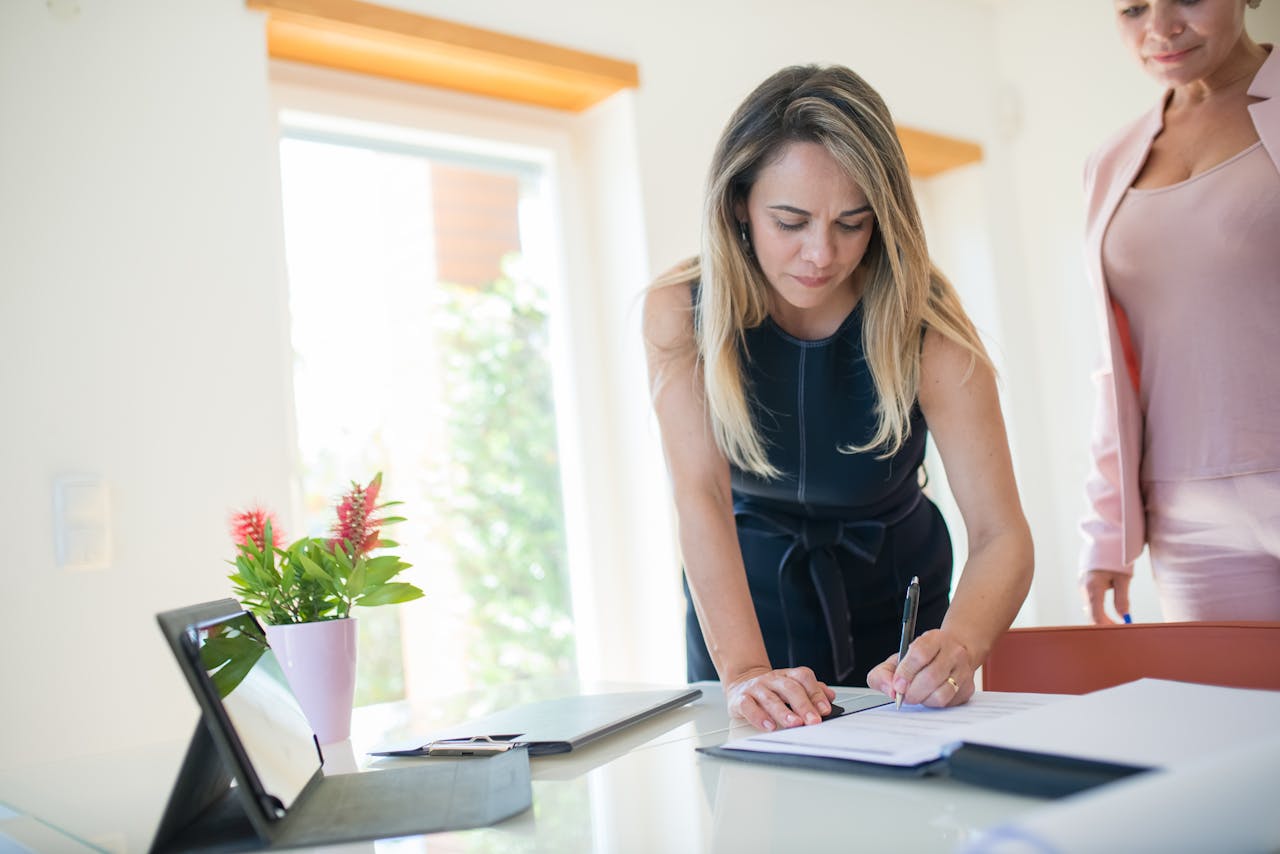 A Woman in a Dress Signing a Document